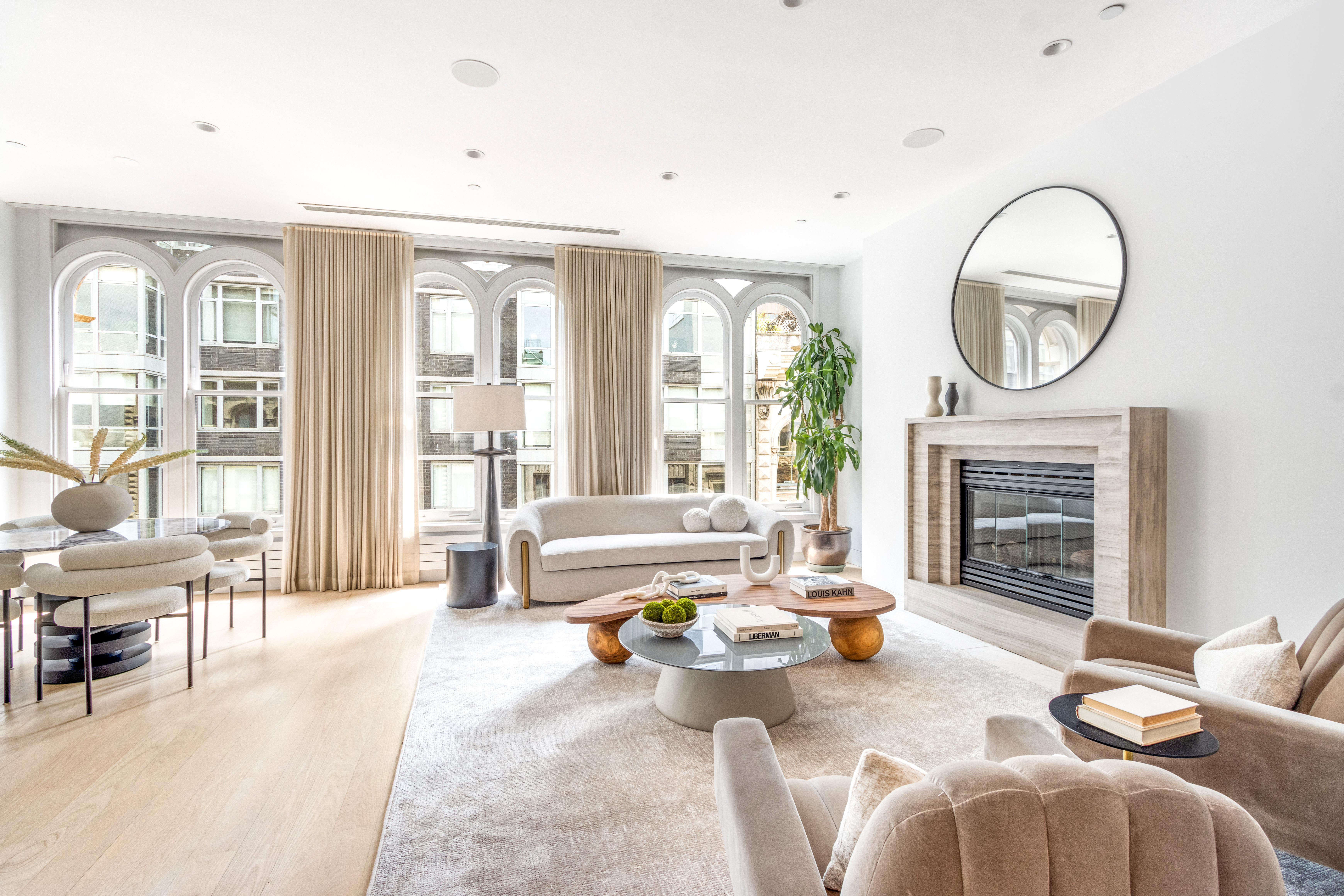 85 Leonard Street, Unit PH Manhattan, NY 10013 - Photo 4 of 27 a living room with furniture a fireplace a large window and a fireplace