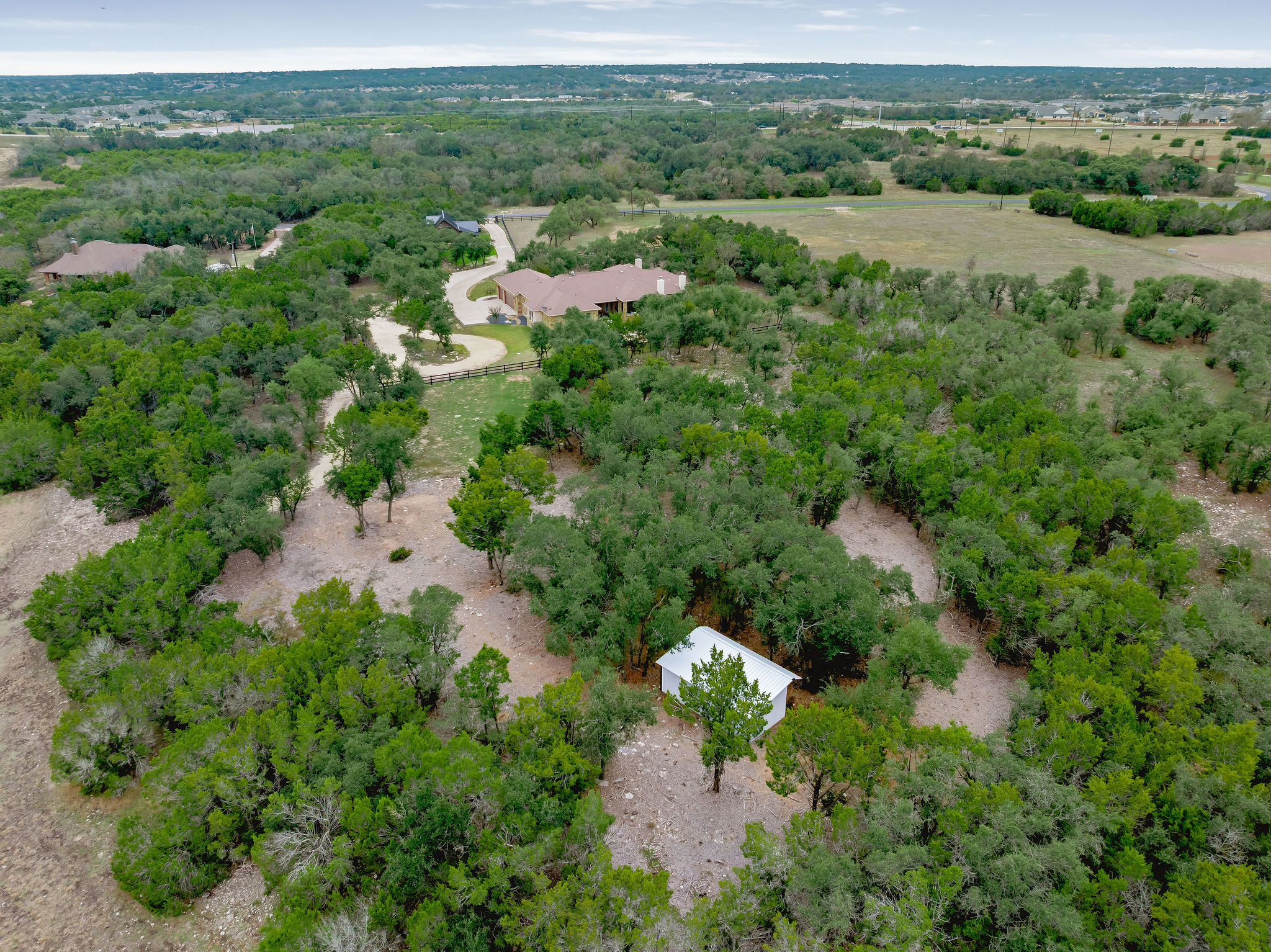 812 Jennings Branch Georgetown, TX 78633 - Photo 95 of 100 an aerial view of green landscape with trees houses and mountain view