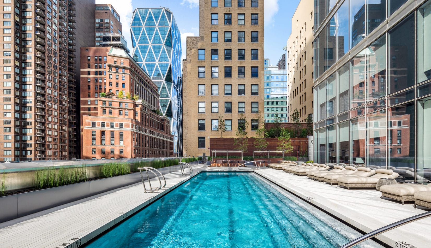 217 West 57th Street, Unit 34F Manhattan, NY 10019 - Photo 22 of 25 a swimming pool with outdoor seating and yard