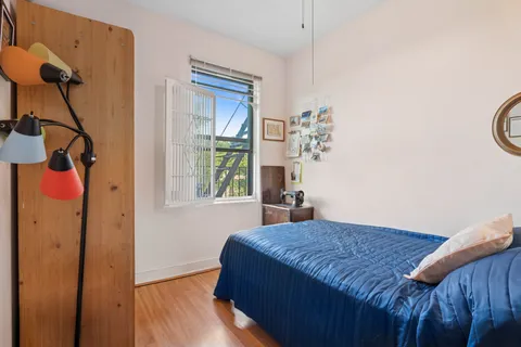 a bedroom with a bed and a window