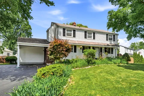 a front view of house with yard and green space