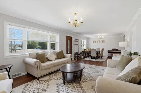 a view of a livingroom with furniture and wooden floor