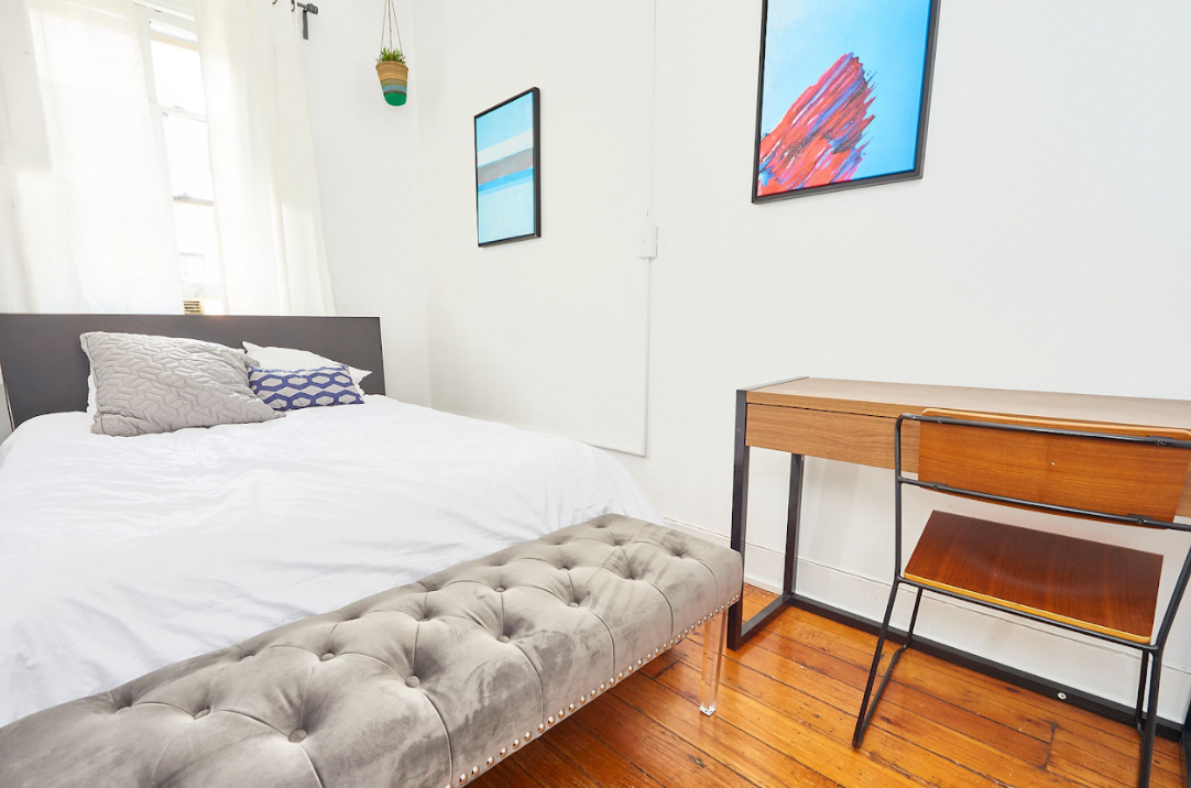 120 East 10th Street, Unit 3 Manhattan, NY 10003 - Photo 7 of 14 a bedroom with a bed and a painting on the wall