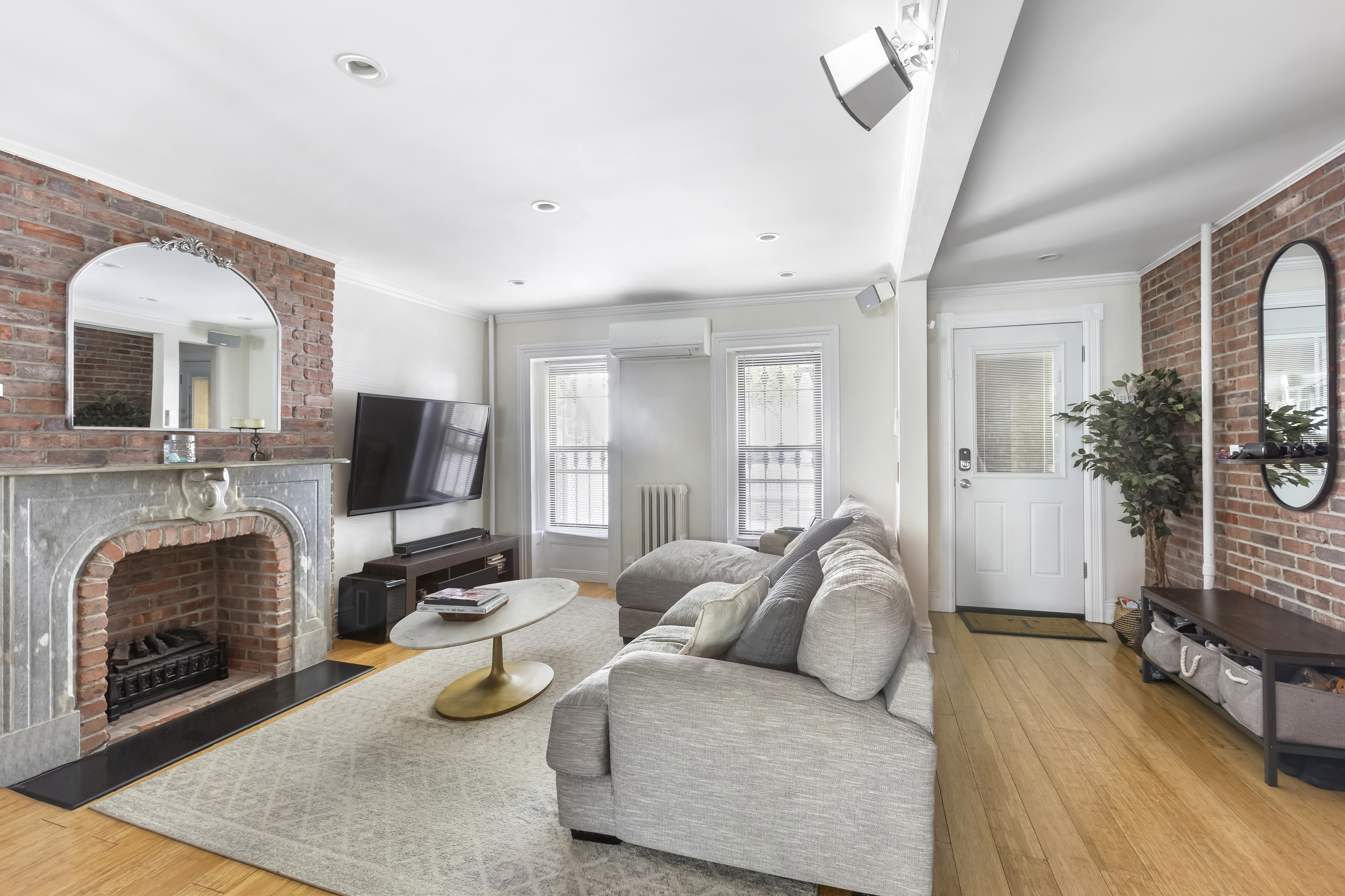 312 10th Street Brooklyn, NY 11215 - Photo 6 of 17 a living room with furniture a fireplace and a flat screen tv