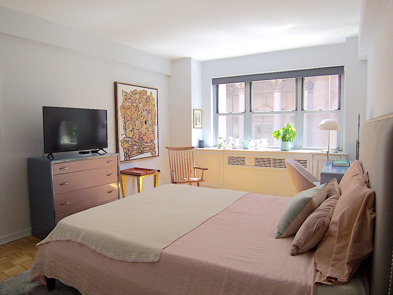 136 East 76th Street, Unit 3E Manhattan, NY 10021 - Photo 6 of 11 a bed room with a bed a television and a window