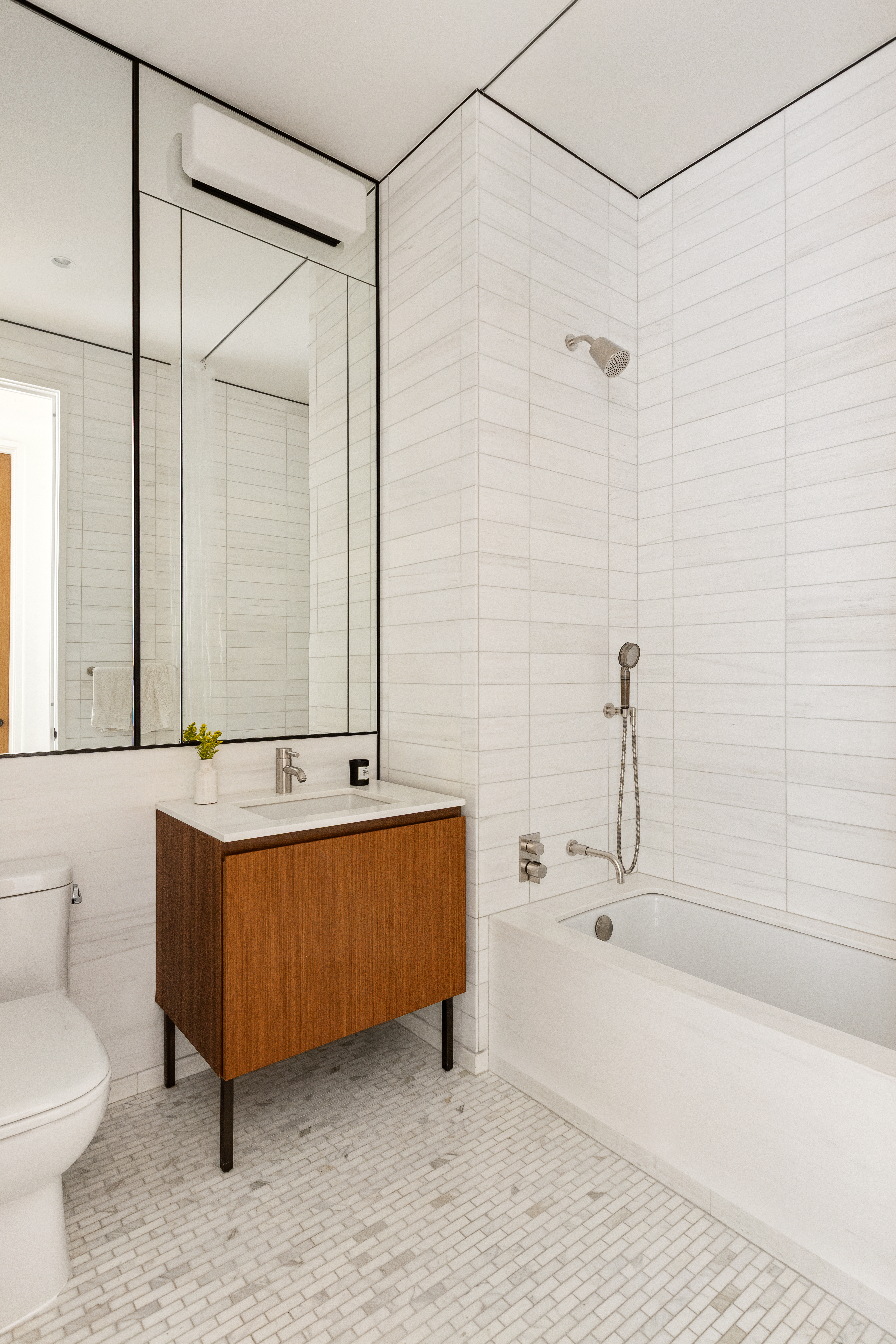 15 East 30th Street, Unit 26C Manhattan, NY 10016 - Photo 7 of 15 a bathroom with a sink and a mirror