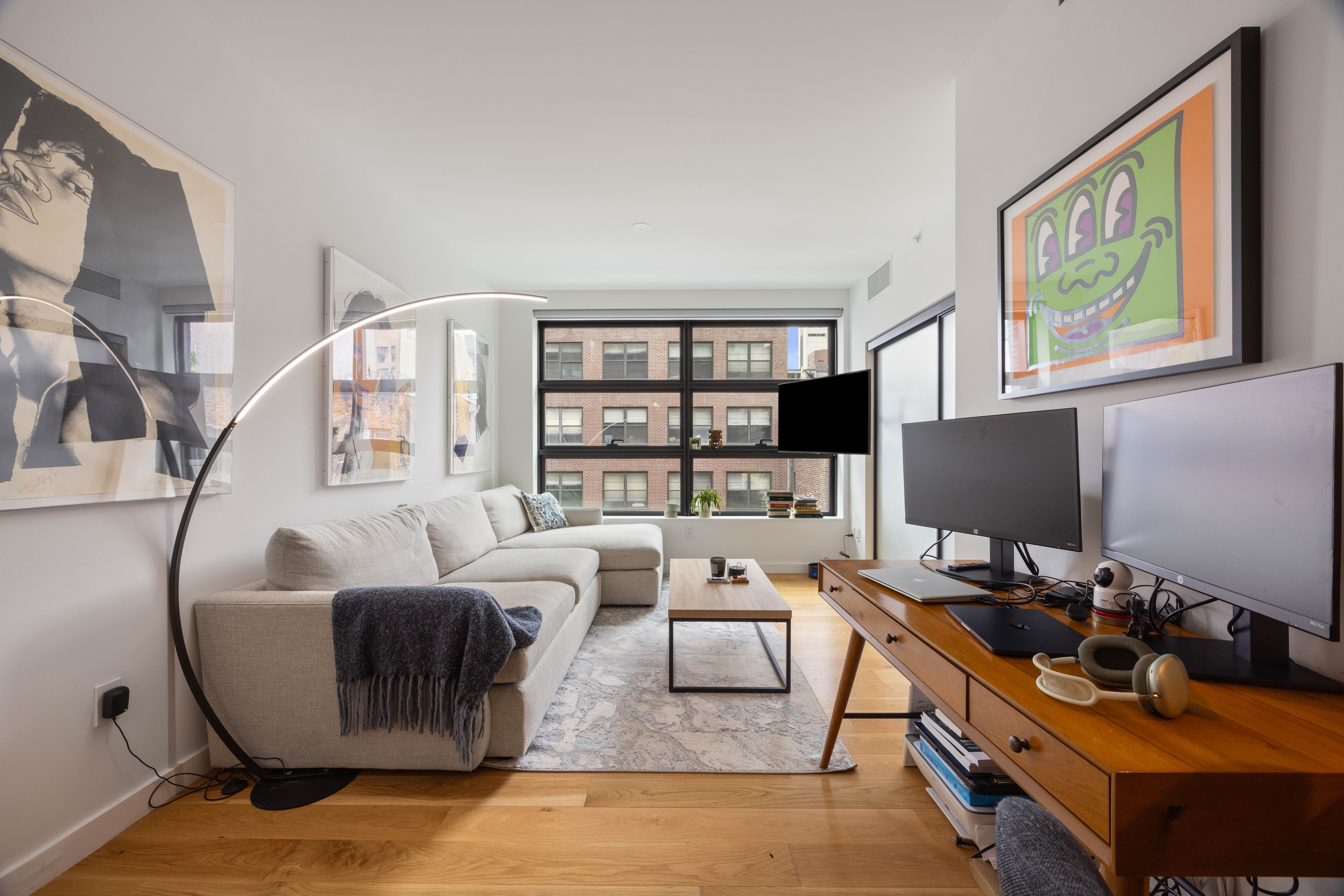 547 West 47th Street, Unit 509 Manhattan, NY 10036 - Photo 5 of 29 a living room with furniture and a flat screen tv