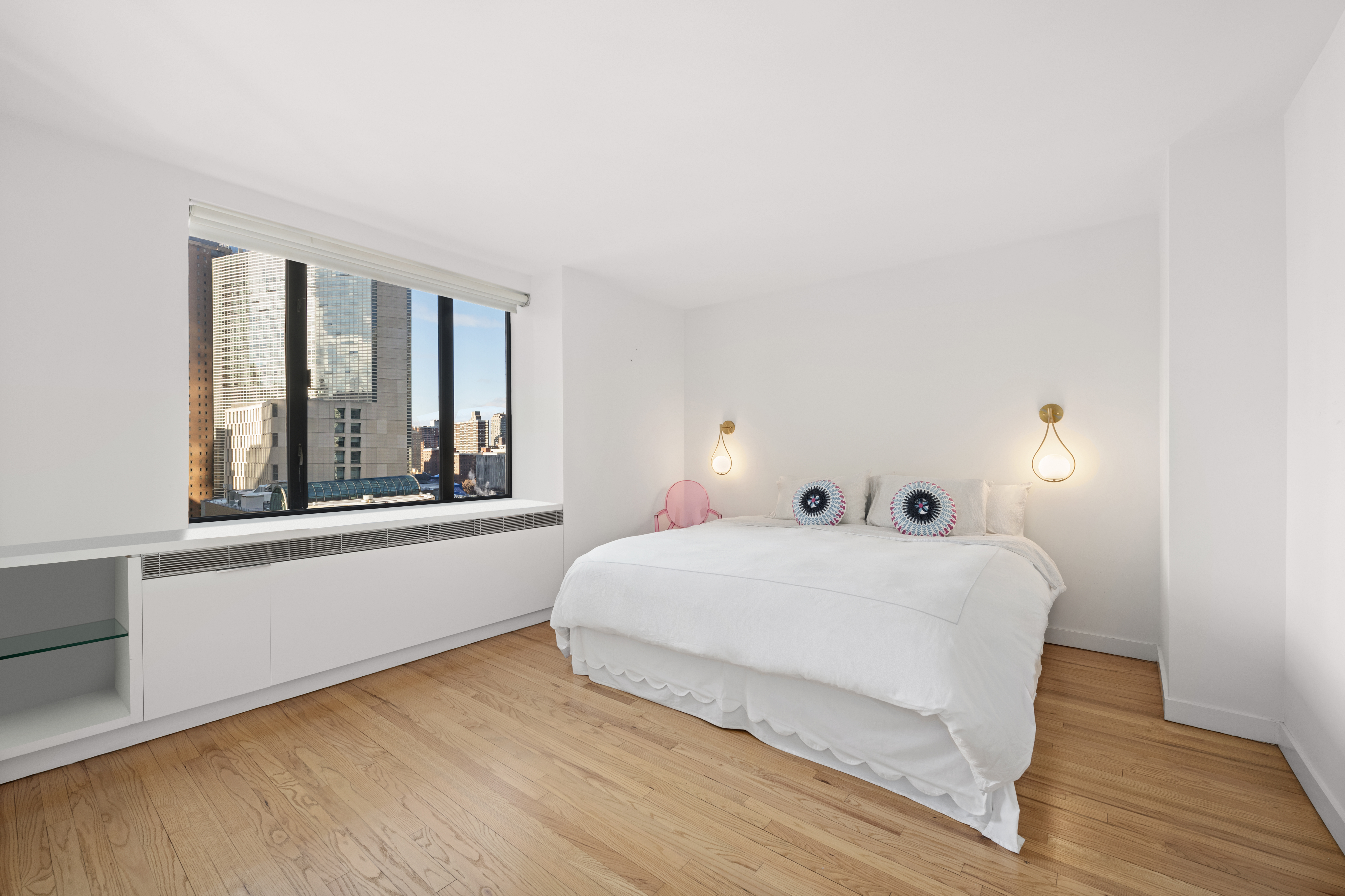 30 West 61st Street, Unit 9C Manhattan, NY 10023 - Photo 4 of 10 a bedroom with a bed and a large window