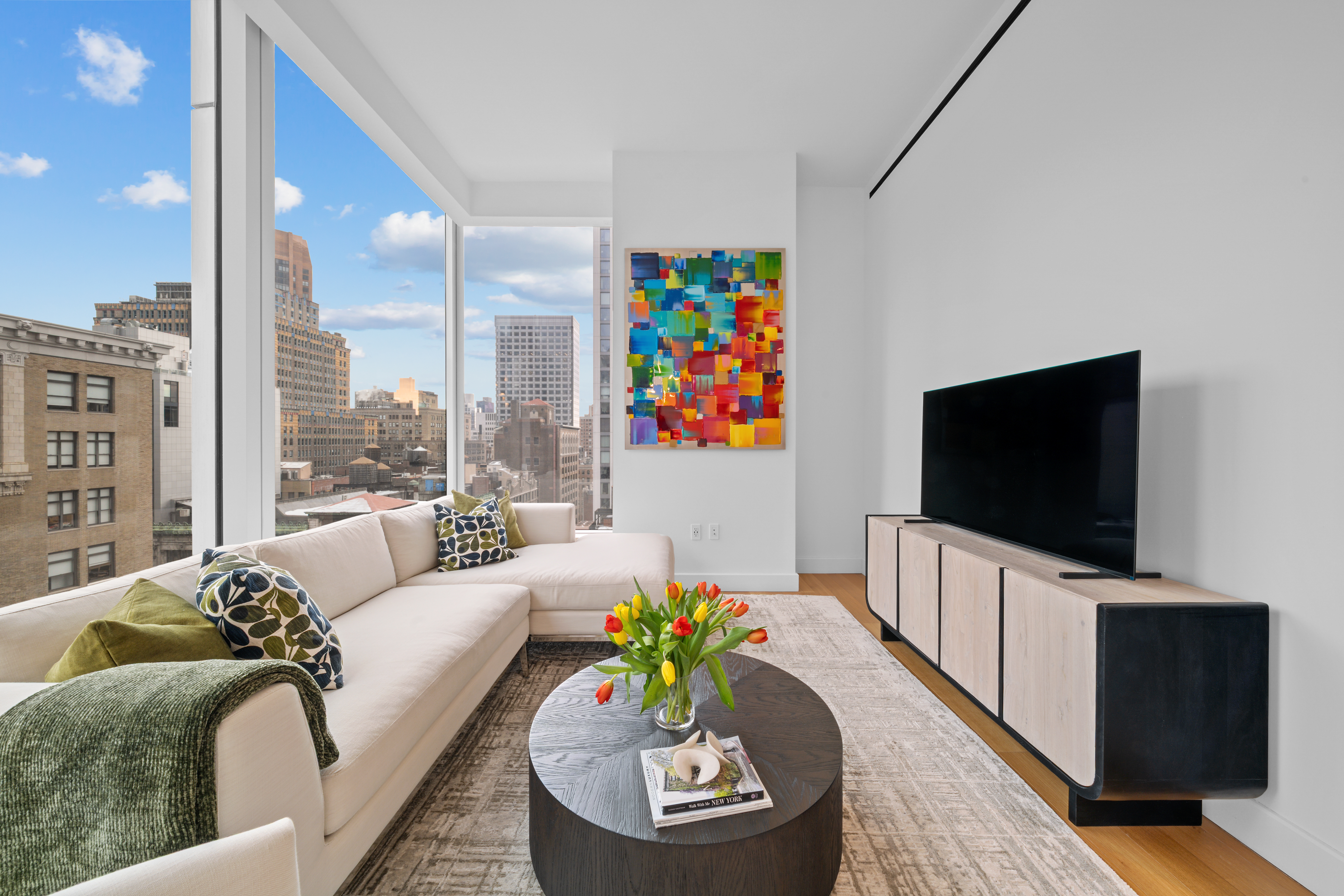 15 East 30th Street, Unit 19B Manhattan, NY 10016 - Photo 10 of 40 a living room with furniture and a flat screen tv