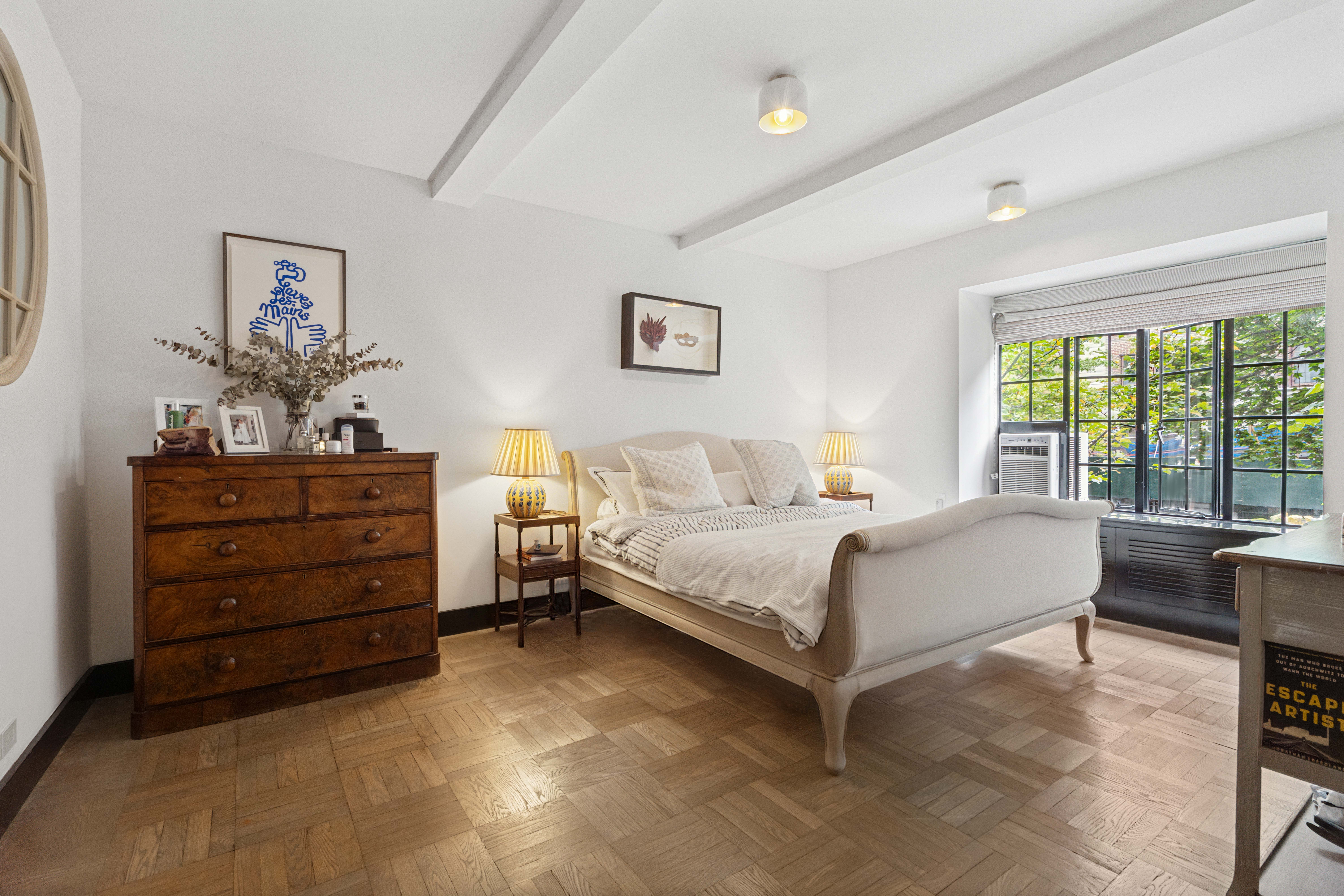 25 Monroe Place, Unit 2A Brooklyn, NY 11201 - Photo 3 of 14 a bedroom with a bed and a dresser