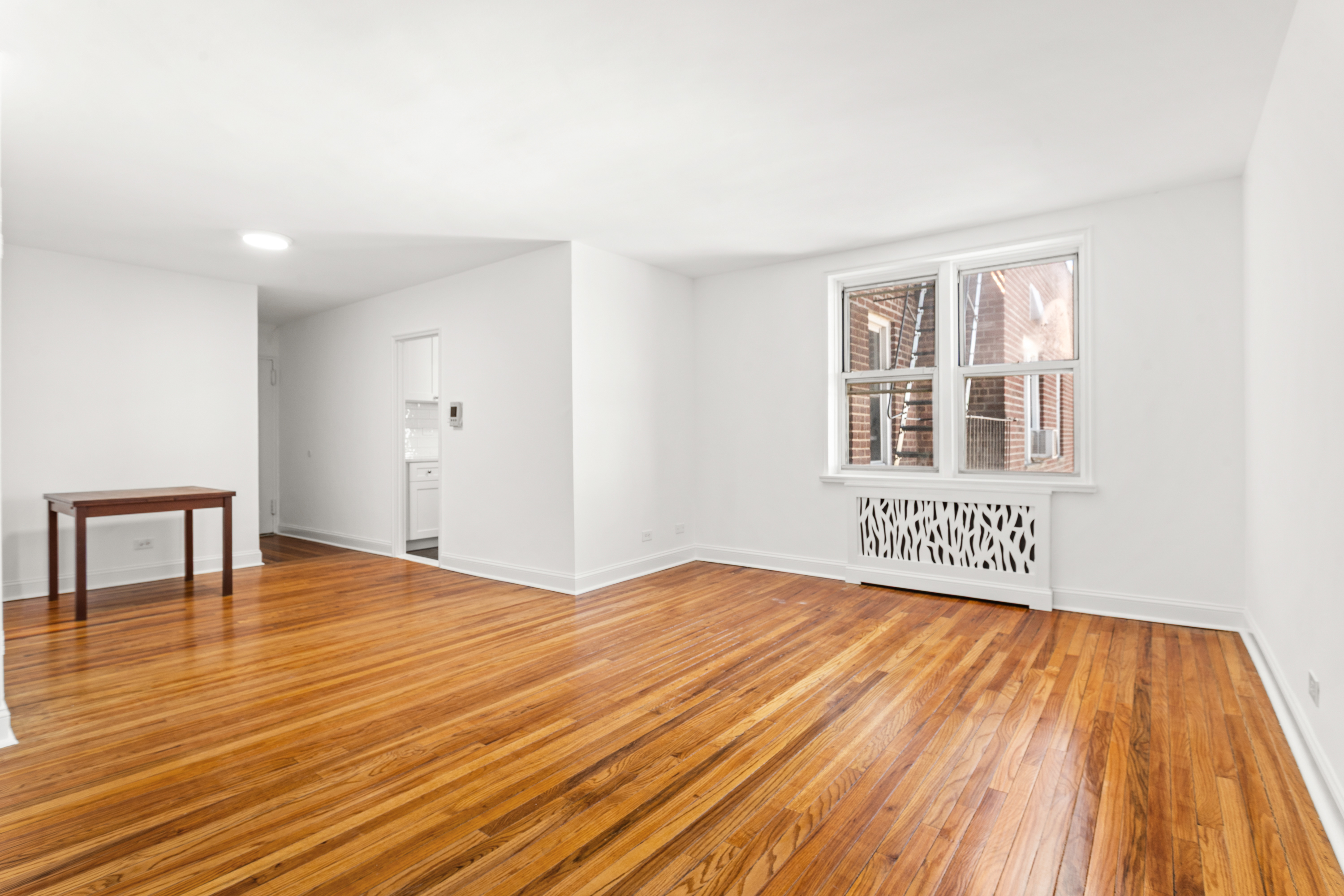 5650 Netherland Avenue, Unit 6C Bronx, NY 10471 - Photo 8 of 16 a view of an empty room with wooden floor and a window
