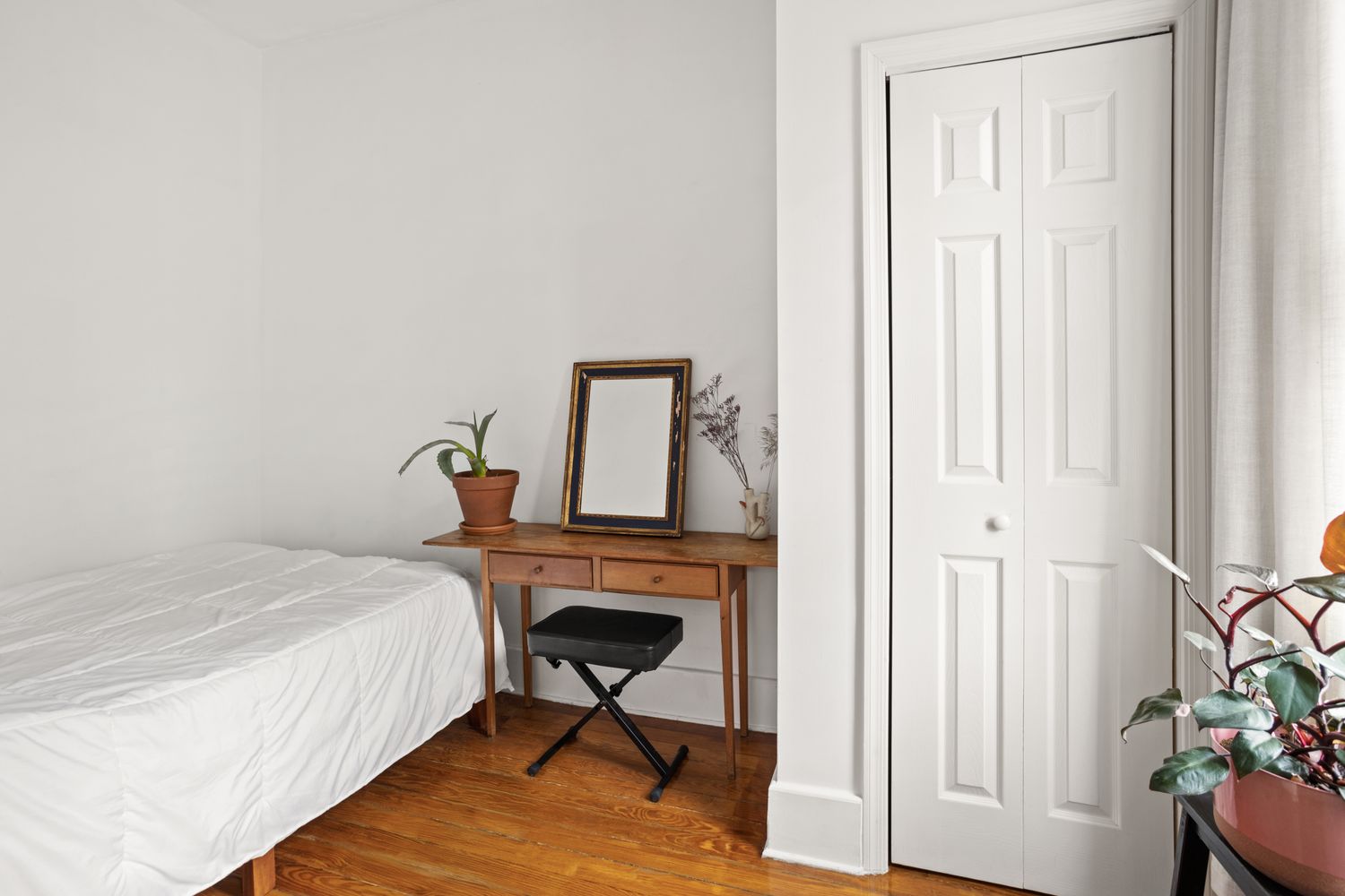 a bedroom with a bed and a table in it