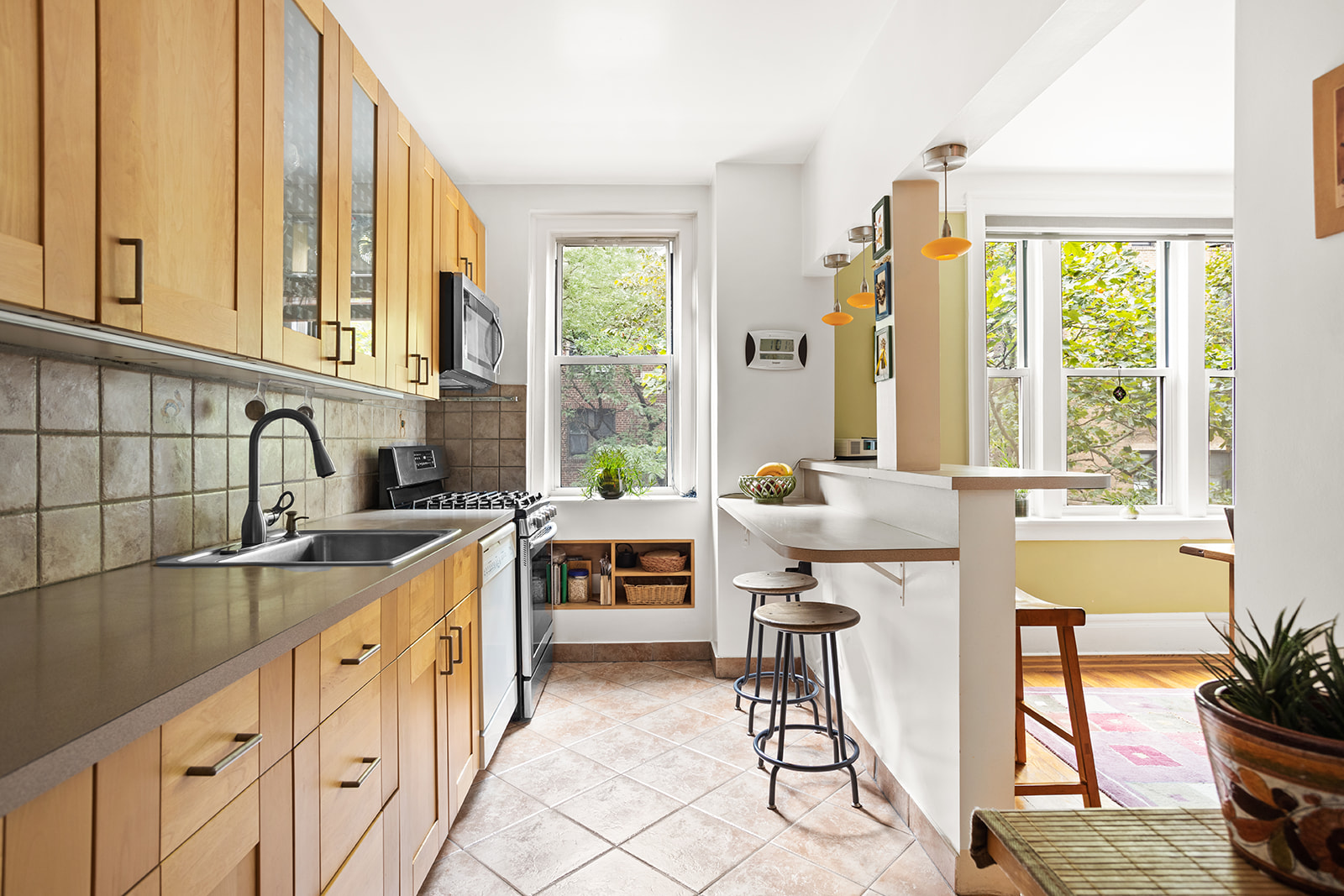 35-56 79th Street, Unit 22 Queens, NY 11372 - Photo 5 of 14 a kitchen with sink cabinets and dining table
