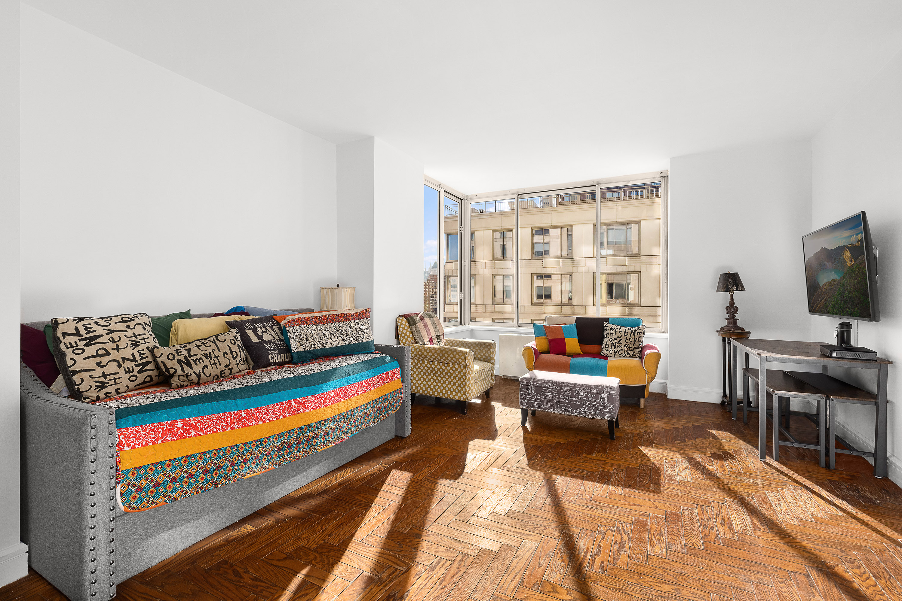 200 Riverside Boulevard, Unit 15F Manhattan, NY 10069 - Photo 2 of 11 a living room with furniture and a flat screen tv