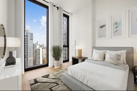 a bathroom with a granite countertop sink a mirror and a toilet