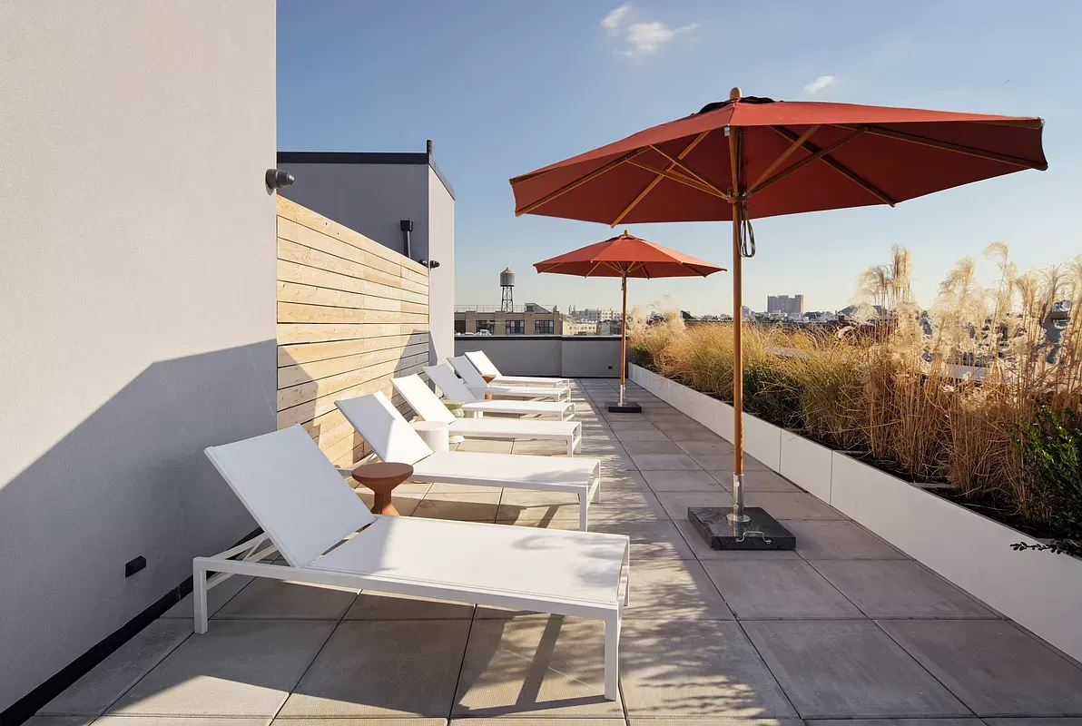 a view of a patio with a table and chairs under an umbrella