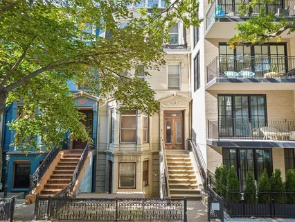 a view of a brick building next to a yard