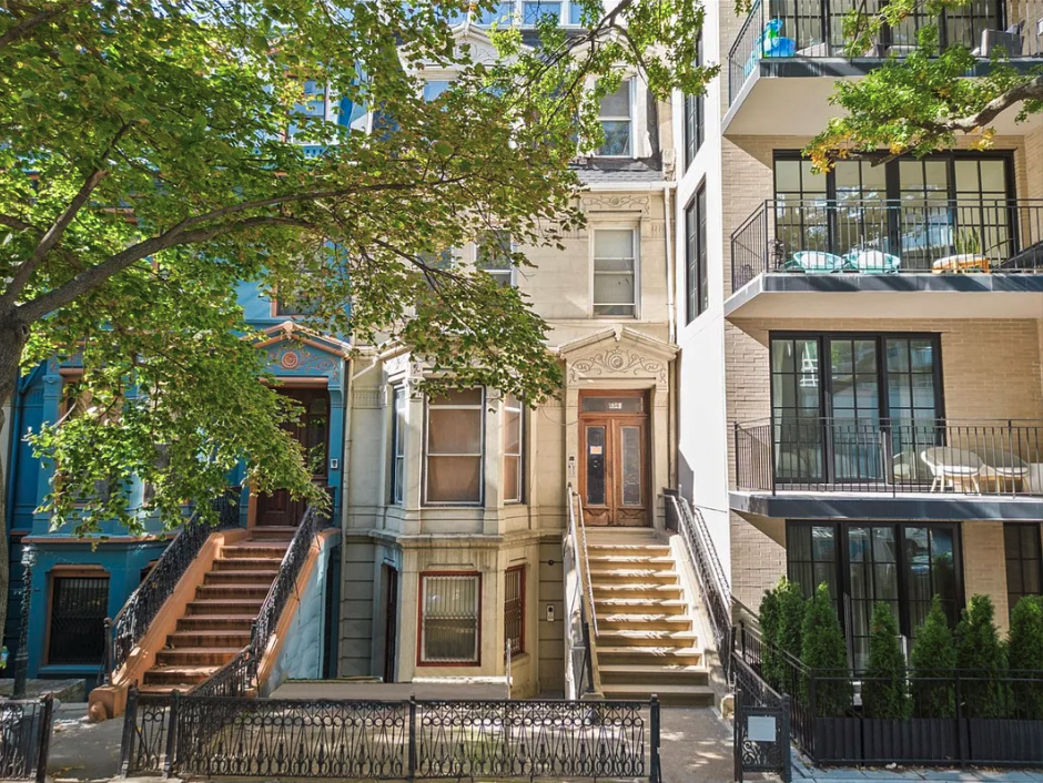 a view of a brick building next to a yard