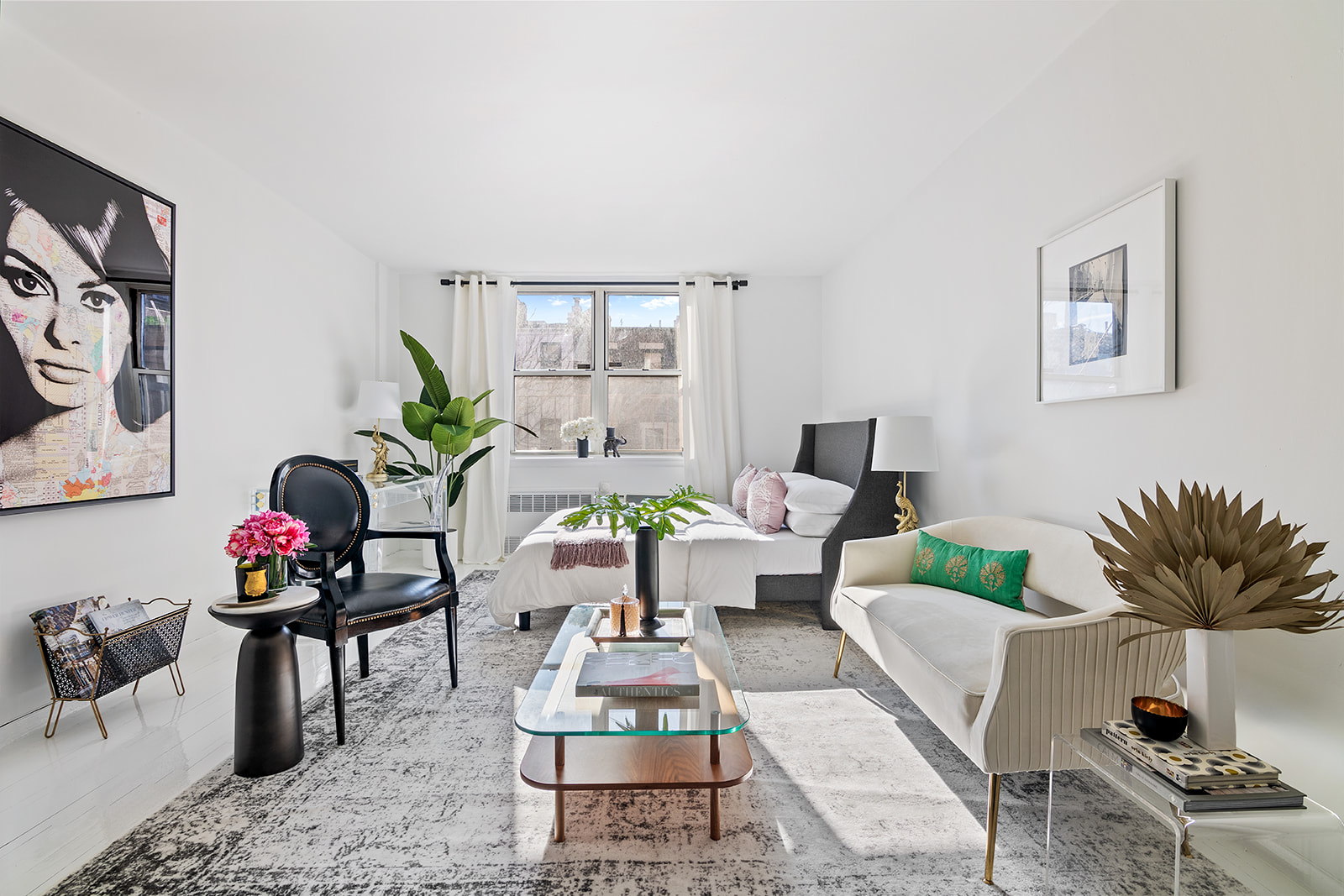a living room with furniture a rug and a potted plant