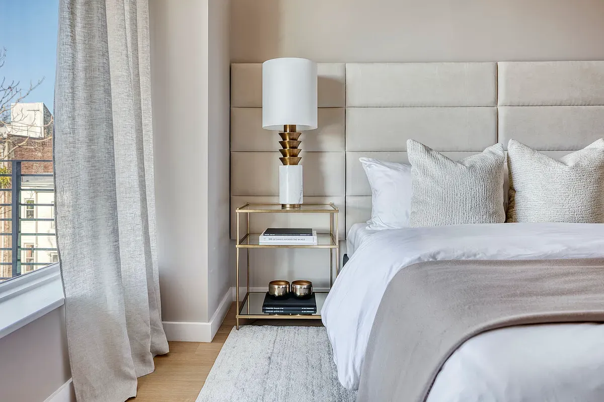 a bedroom with a bed and a large mirror