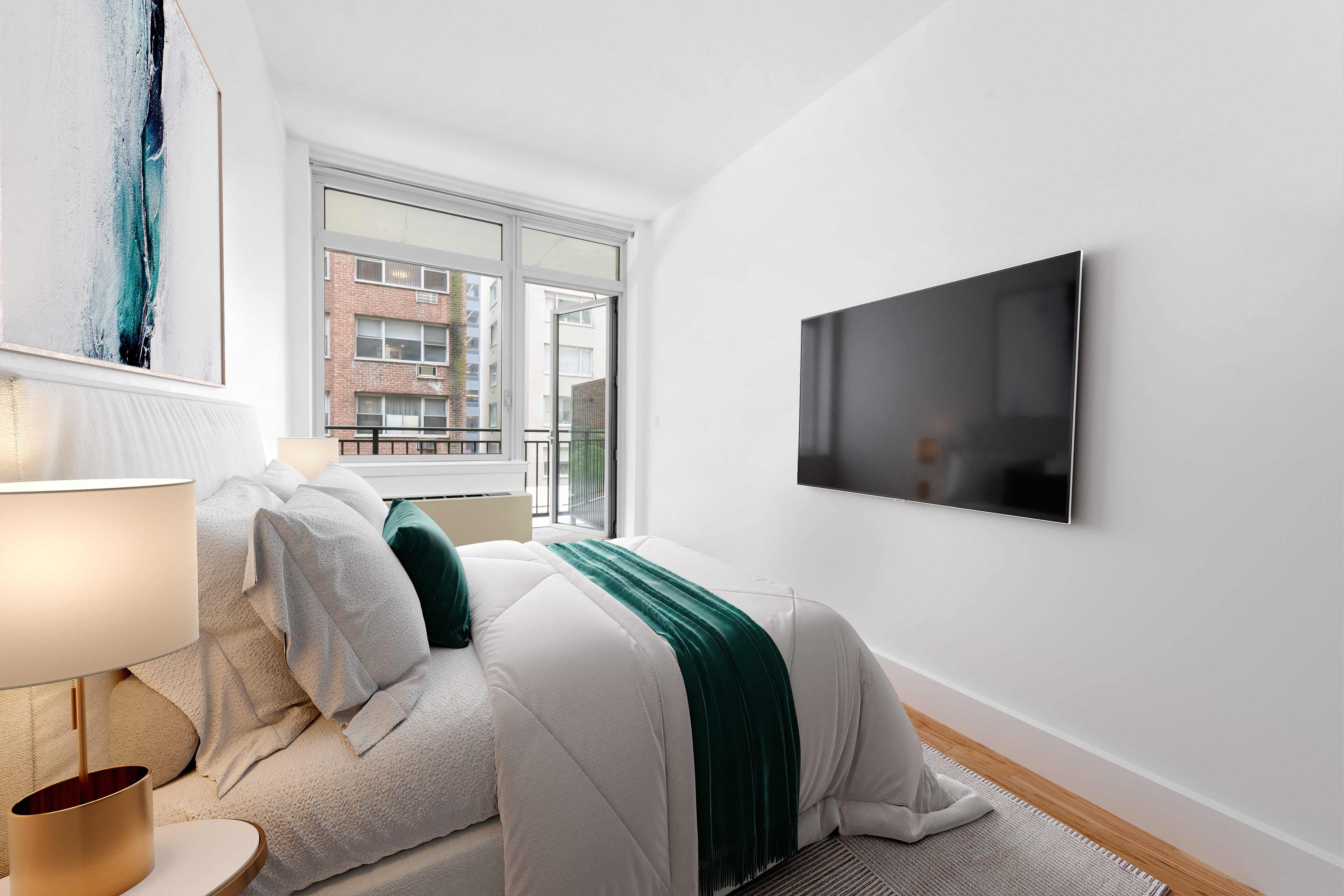 212 East 57th Street, Unit 3B Manhattan, NY 10022 - Photo 15 of 17 a bedroom with bed and a flat screen tv