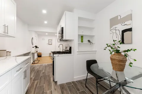 a kitchen with stainless steel appliances granite countertop sink stove top oven and cabinets