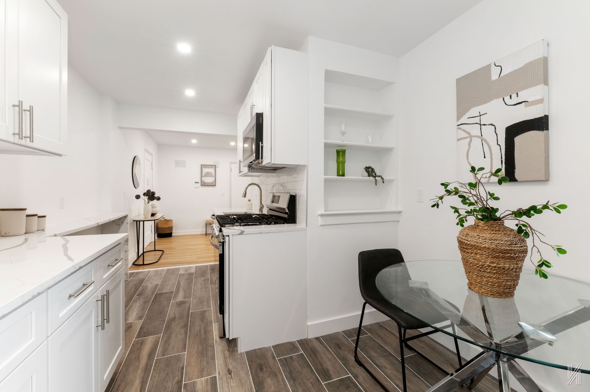 34-41 85th Street, Unit 1U Queens, NY 11372 - Photo 11 of 24 a kitchen with stainless steel appliances granite countertop sink stove top oven and cabinets