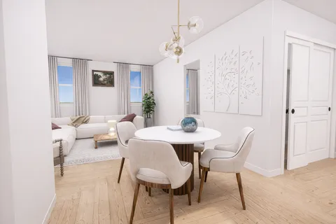 a view of a dining room with furniture and chandelier