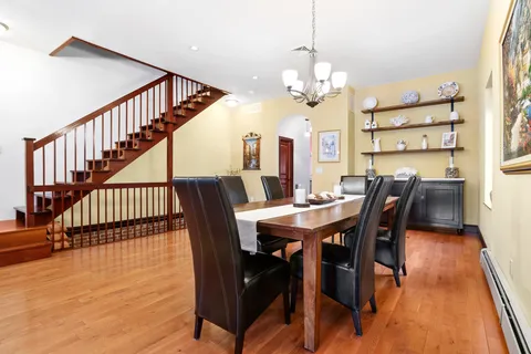 a view of a dining room with furniture and wooden floor