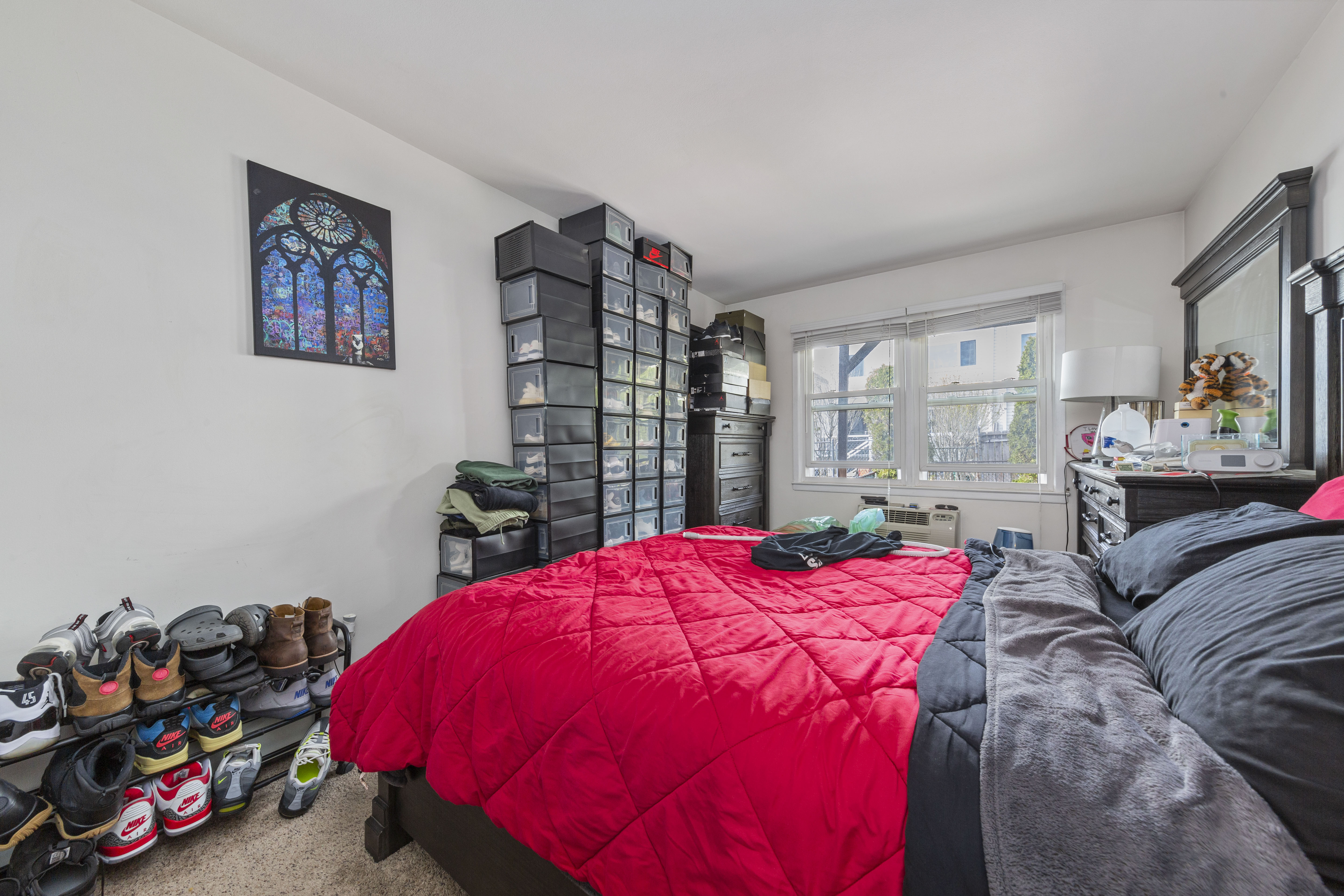 240-47 68th Avenue Queens, NY 11362 - Photo 11 of 39 a bedroom with a bed and a large mirror on dresser in it