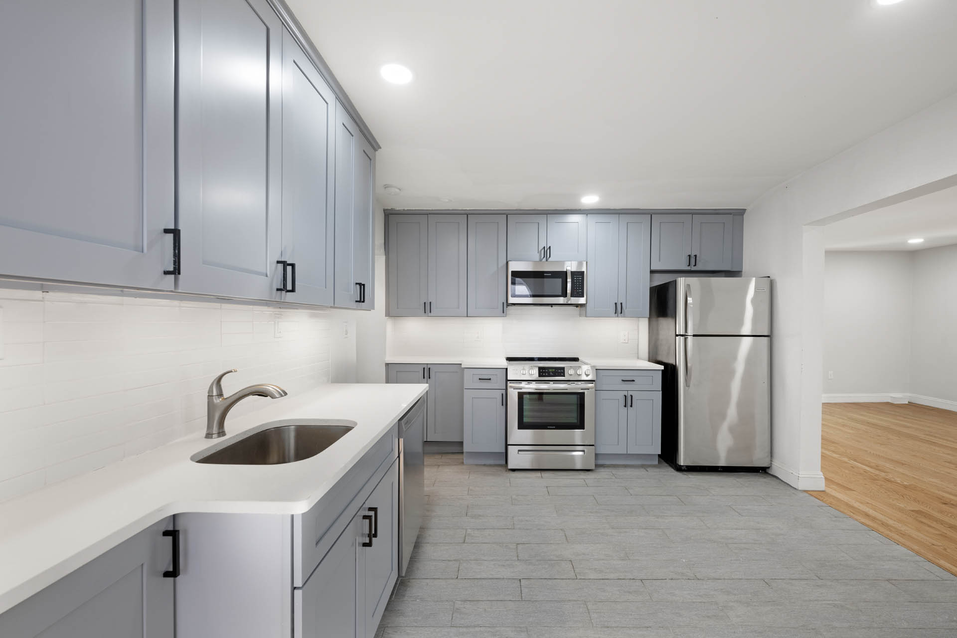 156 Summit Place, Unit 2 Bronx, NY 10463 - Photo 2 of 10 a kitchen with a sink a refrigerator and cabinets