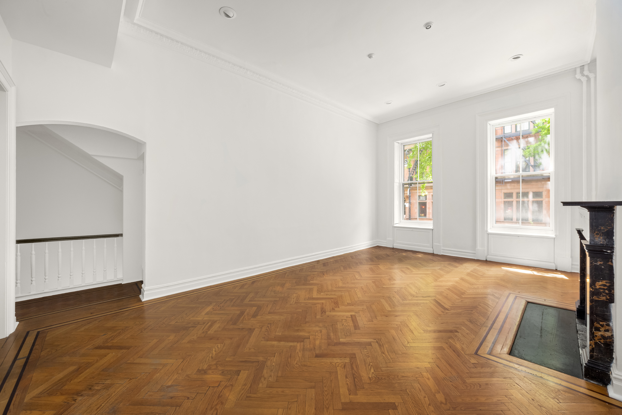 57 West 9th Street Manhattan, NY 10011 - Photo 3 of 11 a view of an empty room with window and a kitchen