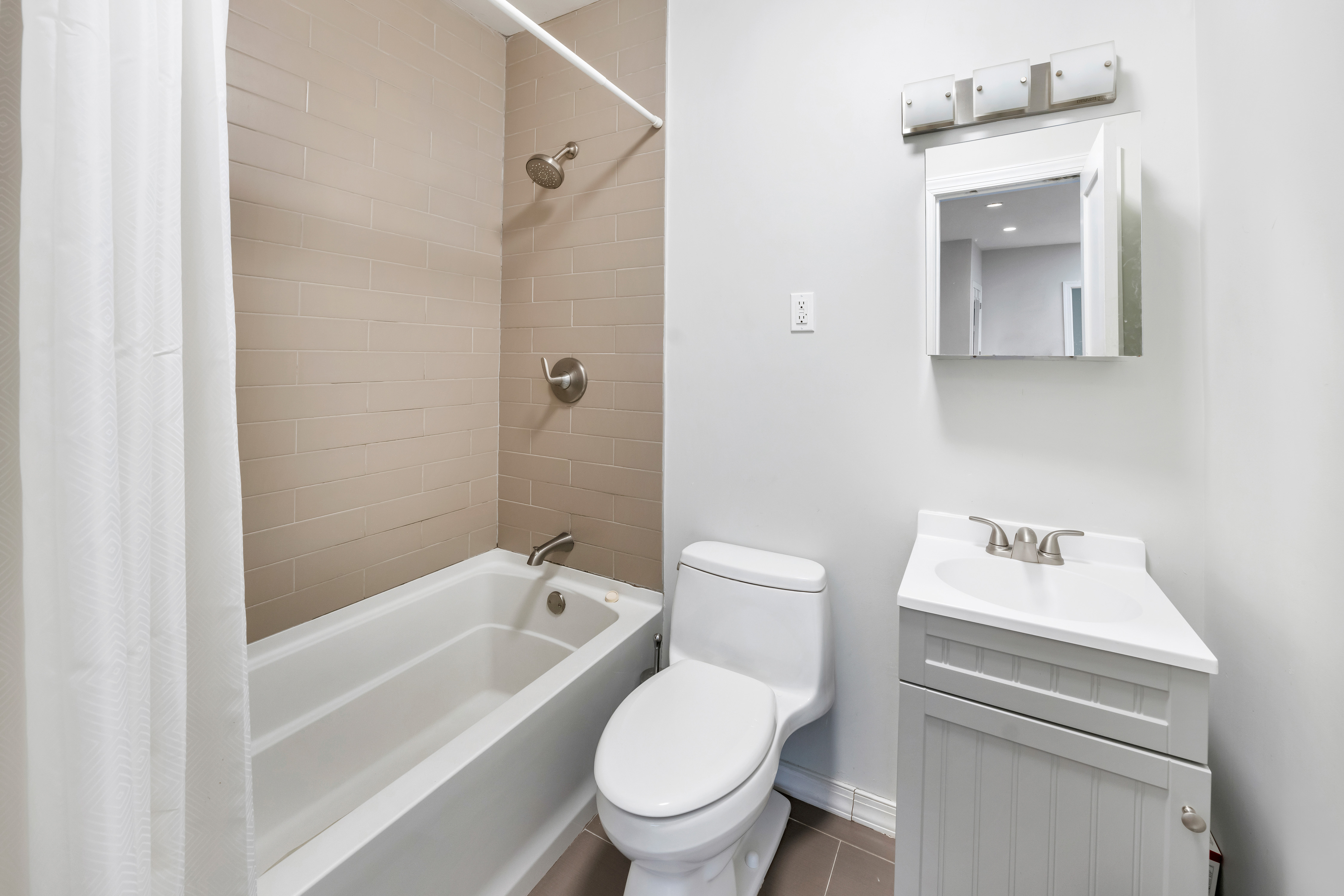 354 Grand Street Brooklyn, NY 11211 - Photo 10 of 14 a white toilet sitting next to a bath tub