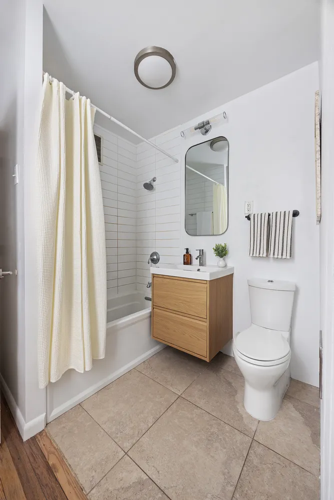 a bathroom with a sink a mirror and a toilet