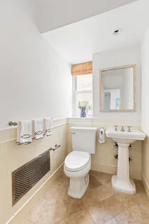 a bathroom with a sink a toilet and mirror
