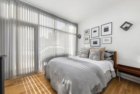 a bedroom with a bed and a window