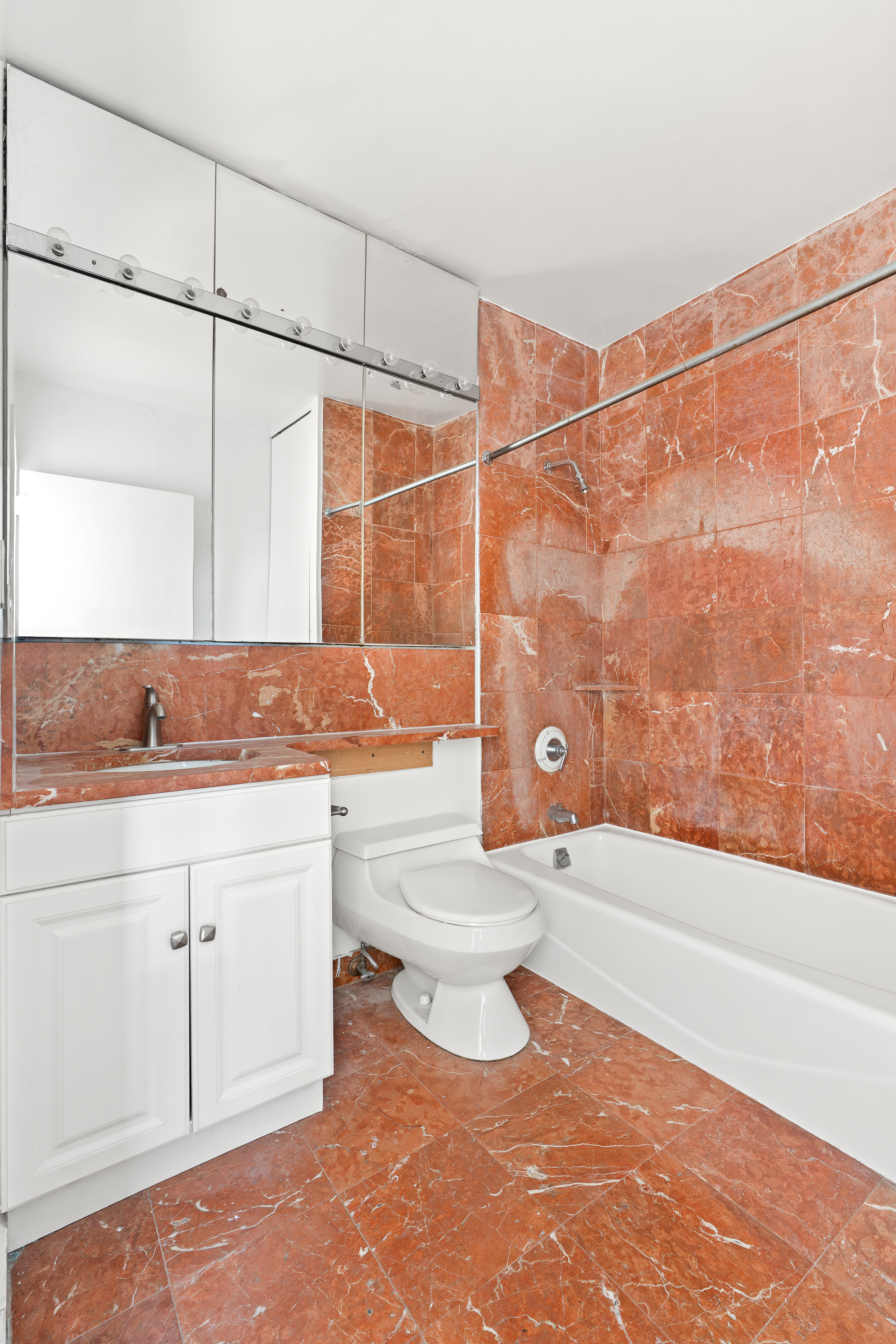 343 East 74th Street, Unit 7L Manhattan, NY 10021 - Photo 6 of 11 a bathroom with a sink a toilet and bathtub