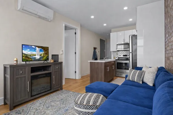 a living room with furniture and a flat screen tv