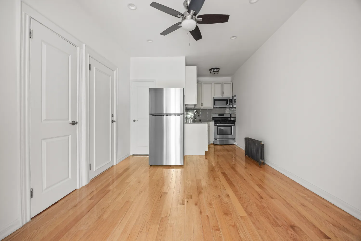 a kitchen with stainless steel appliances a refrigerator and a stove top oven