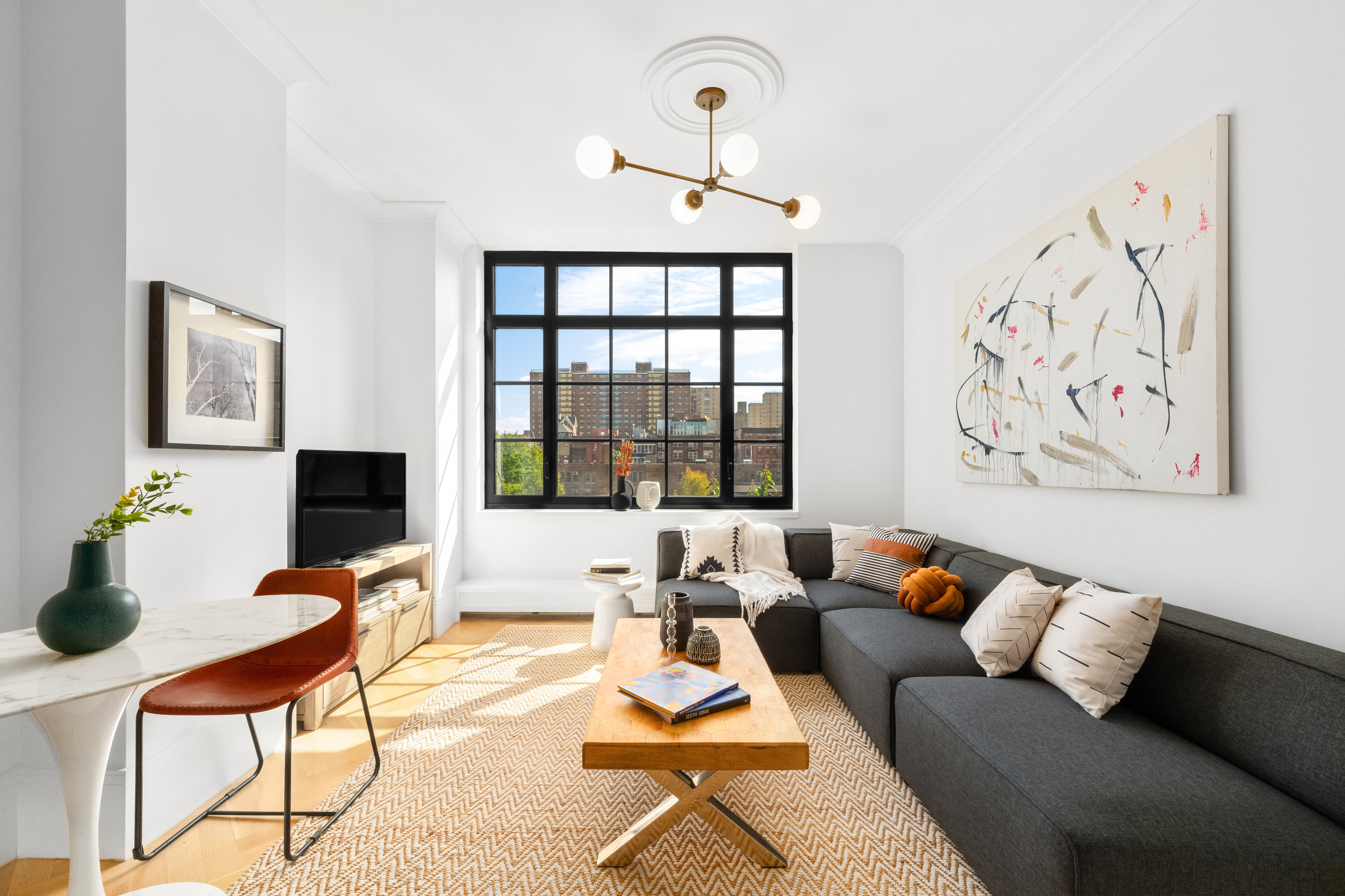 a living room with furniture and wooden floor