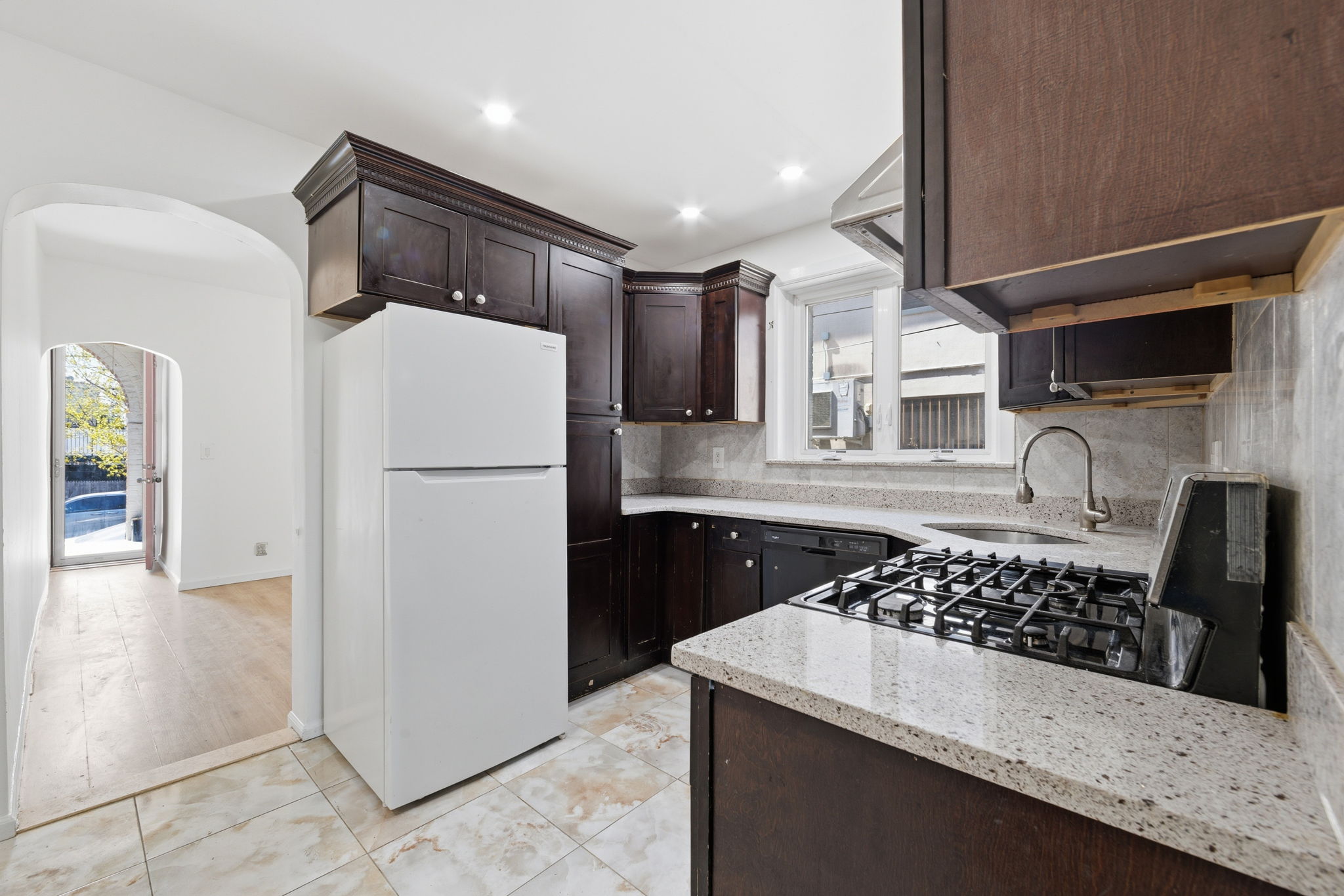 37 Chester Avenue Brooklyn, NY 11218 - Photo 5 of 14 a kitchen with stainless steel appliances granite countertop a sink stove and refrigerator