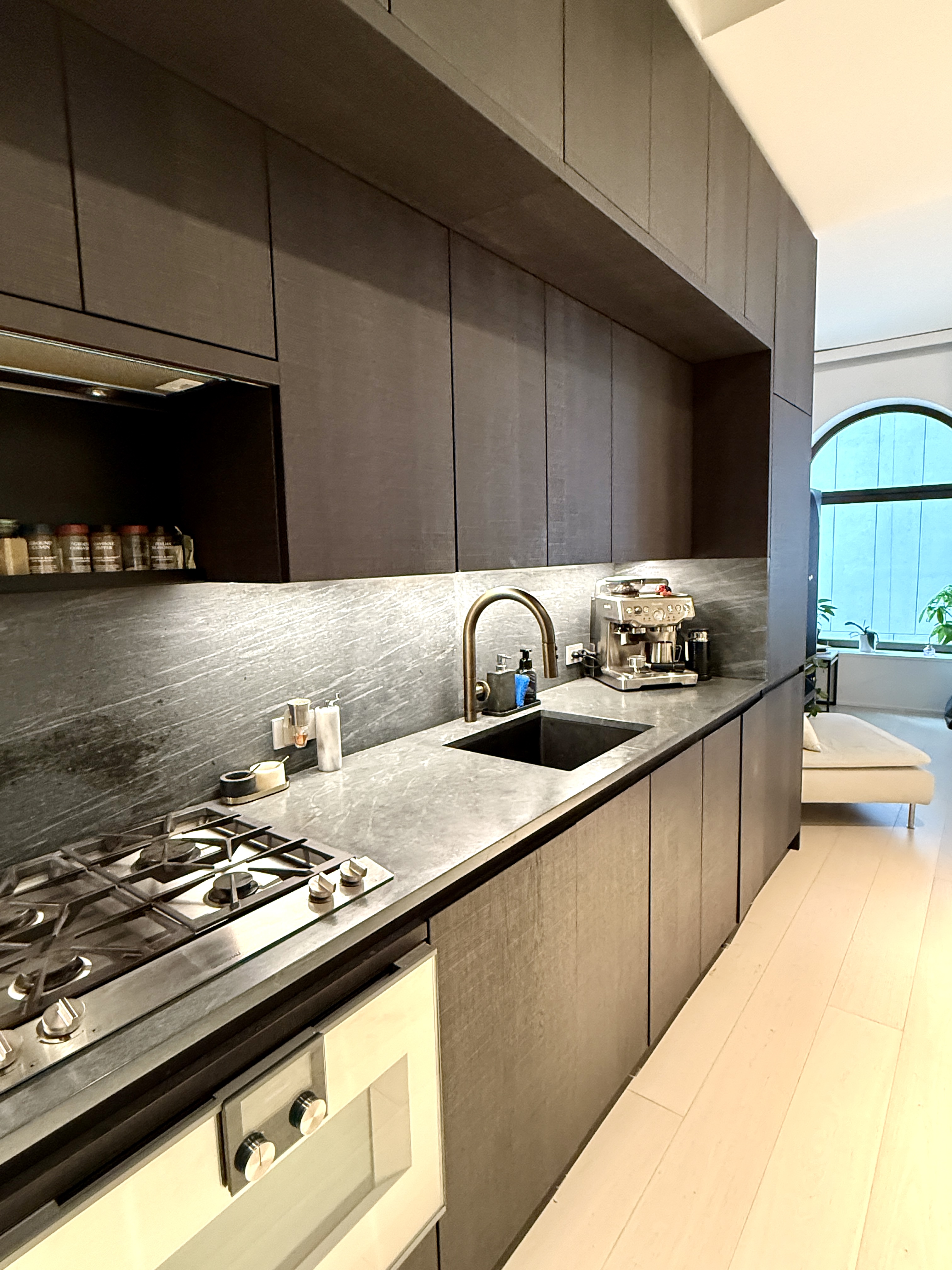 130 William Street, Unit 9E Manhattan, NY 10038 - Photo 6 of 16 a kitchen with a sink a stove and cabinets