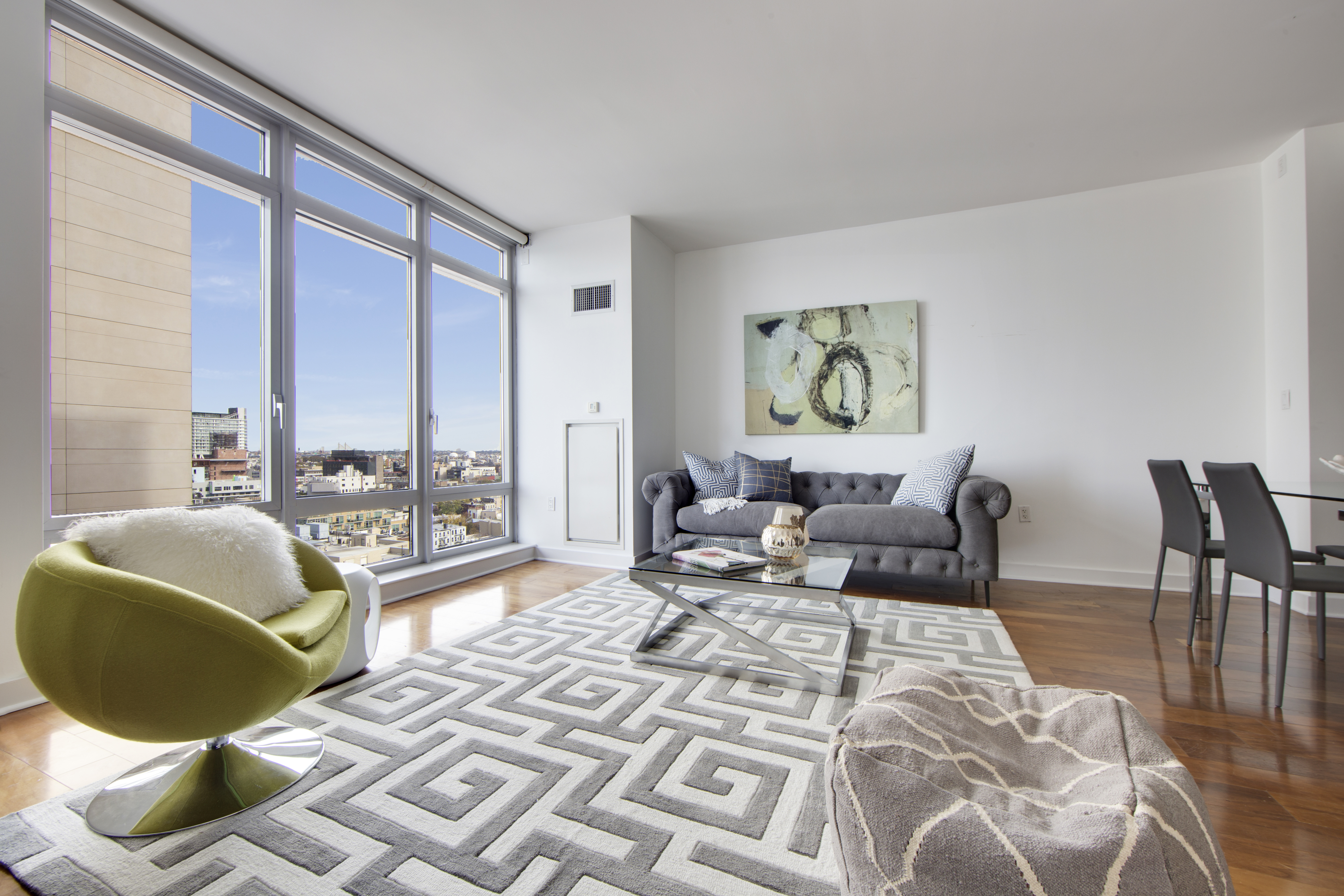 2 Northside Piers, Unit 8H Brooklyn, NY 11249 - Photo 3 of 20 a living room with furniture and a large window
