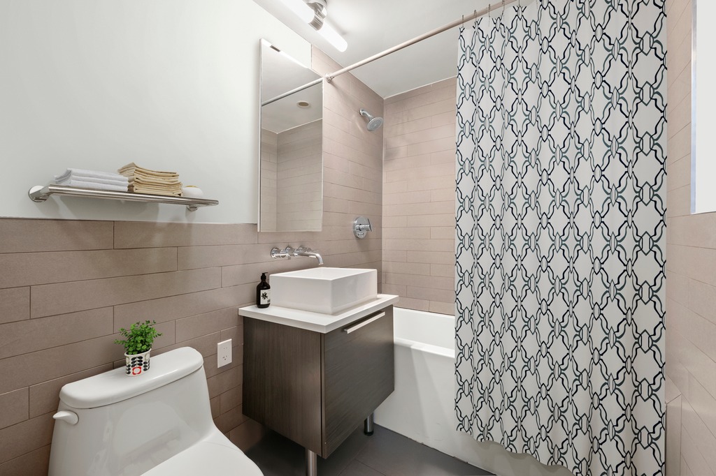 122 West Street, Unit PHA Brooklyn, NY 11222 - Photo 7 of 14 a bathroom with a sink toilet and shower