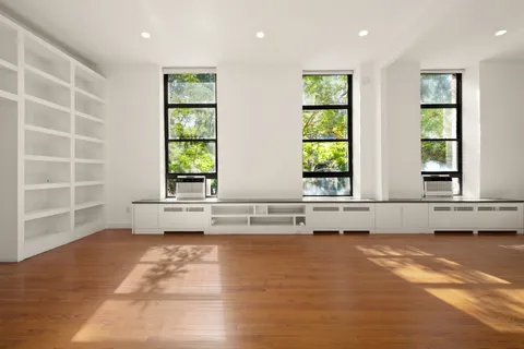 a view of a kitchen with a sink and cabinets
