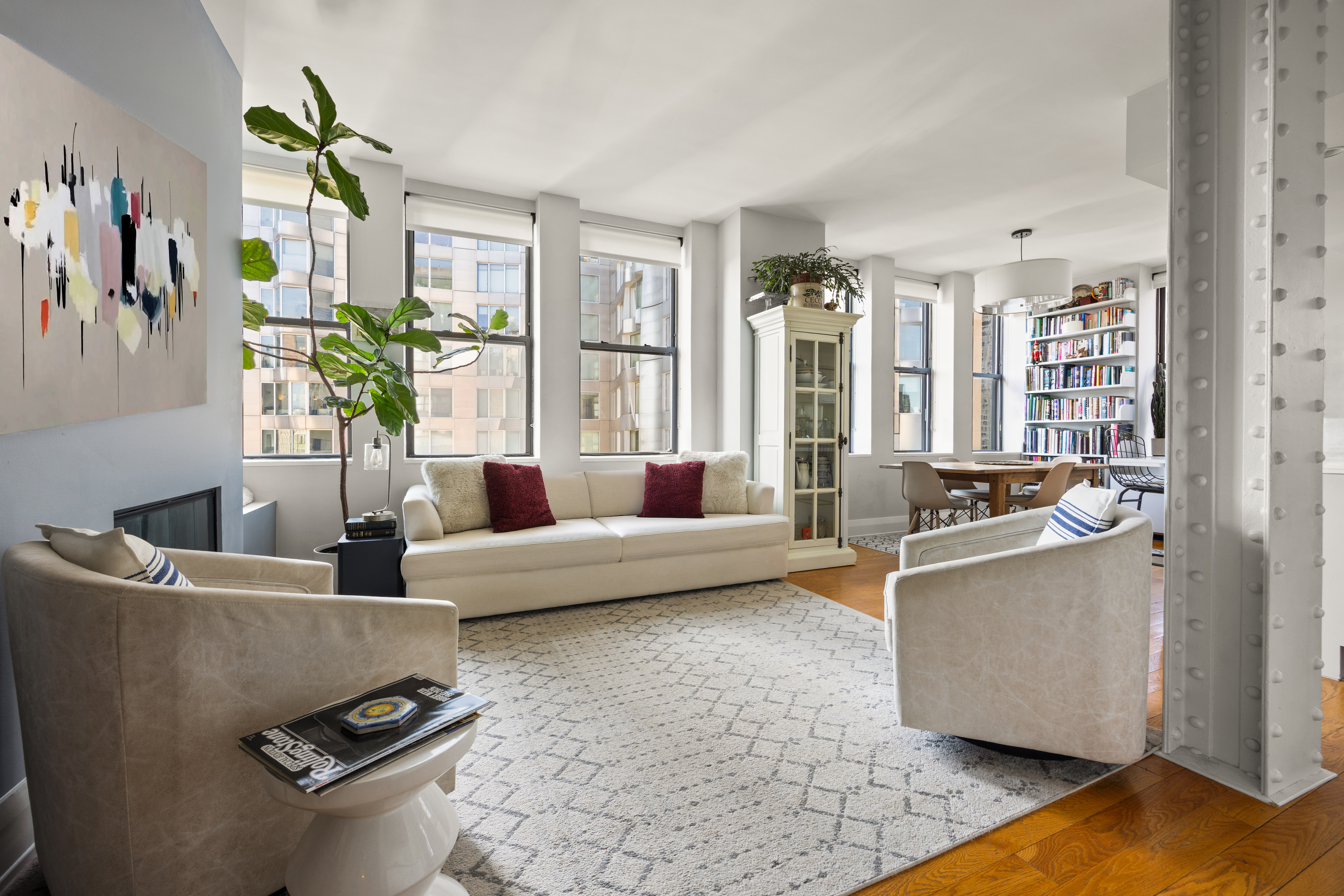 a living room with furniture and a potted plant