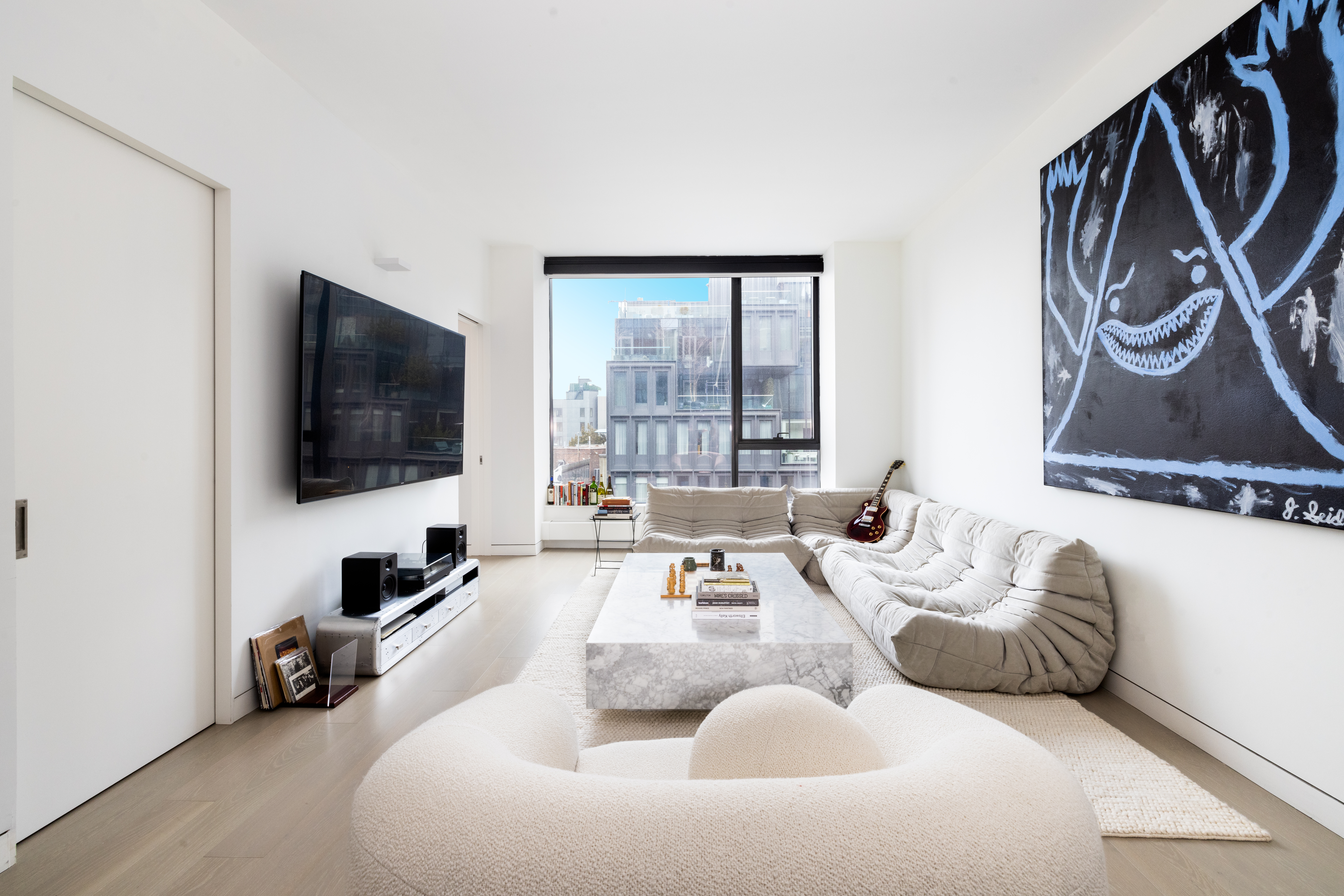 255 Hudson Street, Unit 9C Manhattan, NY 10013 - Photo 2 of 19 a living room with furniture and a flat screen tv