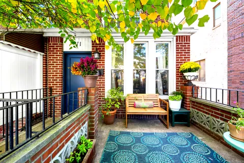 a balcony with furniture and a potted plant