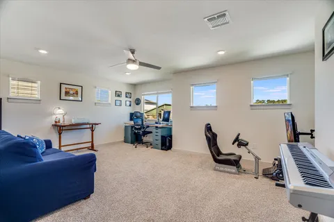 a living room with furniture a dining table and a piano