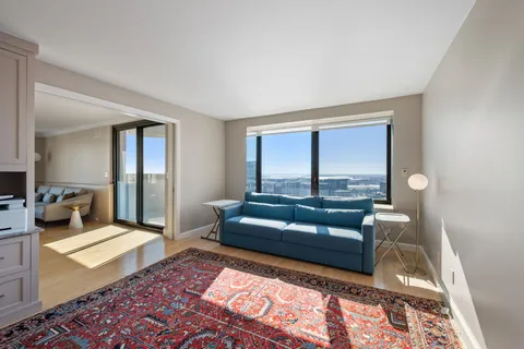 a living room with a couch and a rug